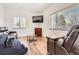 Comfortable living room with leather seating, TV, and natural light from the windows at 6102 S Aberdeen St, Littleton, CO 80120