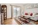 Cozy living room featuring a couch with decorative pillows, a wooden coffee table, and hardwood flooring at 6102 S Aberdeen St, Littleton, CO 80120