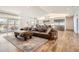 Open-concept living room flows into a modern kitchen with stainless appliances and a large island at 6102 S Aberdeen St, Littleton, CO 80120