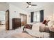 Comfortable main bedroom with ceiling fan, dresser, closet and plush carpet at 6102 S Aberdeen St, Littleton, CO 80120