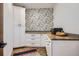 Convenient pantry space featuring custom cabinets, wood countertops, and designer wallpaper at 6102 S Aberdeen St, Littleton, CO 80120