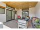 Relaxing patio with a wood-paneled ceiling, sliding glass doors, and plenty of comfortable seating at 6102 S Aberdeen St, Littleton, CO 80120