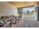 Relaxing covered patio with modern furniture, stylish rugs, and a serene outdoor view at 6102 S Aberdeen St, Littleton, CO 80120