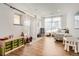 Bright playroom featuring hardwood floors, large windows, and ample space for creative play at 6102 S Aberdeen St, Littleton, CO 80120