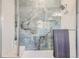 Shower featuring attractive marble tile and modern shower head with glass surround at 6102 S Aberdeen St, Littleton, CO 80120