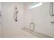 This shower features subway tile, a built-in bench, a shower head and handle set, and a glass shower door at 6102 S Aberdeen St, Littleton, CO 80120