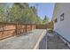 Side yard with garden beds, gravel, and a wooden fence at 6102 S Aberdeen St, Littleton, CO 80120