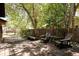 Spacious backyard wooden deck with chairs and a bench, ideal for outdoor relaxation at 1878 S Gilpin St, Denver, CO 80210