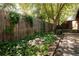 Backyard deck with river stone and landscaped perimeter featuring a wooden fence at 1878 S Gilpin St, Denver, CO 80210