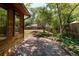 This backyard features a wood deck and a well-maintained lawn, partially shaded by mature trees at 1878 S Gilpin St, Denver, CO 80210