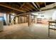 Large basement area with utility equipment, shelves and bare concrete walls at 1878 S Gilpin St, Denver, CO 80210