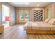 This bedroom has a platform bed, wood floor and a door to the bathroom and another to the backyard at 1878 S Gilpin St, Denver, CO 80210