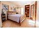 Cozy bedroom with wood floors, built-in shelves, and sunny windows at 1878 S Gilpin St, Denver, CO 80210