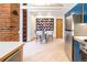 Bright dining area with stainless appliances, brick accent wall, and seating for four at 1878 S Gilpin St, Denver, CO 80210
