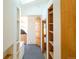 Hallway with wood shelves and a cabinet with folding doors at 1878 S Gilpin St, Denver, CO 80210