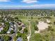 Aerial view featuring homes, a community park, walking paths, and a pond, all nestled within a suburban landscape at 20922 E Crestline Cir, Centennial, CO 80015
