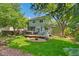 Charming backyard with a spacious wooden deck, ample seating, manicured lawn, and shade trees for relaxing outdoors at 20922 E Crestline Cir, Centennial, CO 80015