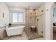Bathroom featuring glass shower, claw footed tub, and large window at 20922 E Crestline Cir, Centennial, CO 80015