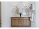 Bathroom boasts double sinks, framed mirrors, and ample storage in wood cabinets at 20922 E Crestline Cir, Centennial, CO 80015