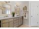 Bathroom boasts double sinks, framed mirrors, and ample storage in wood cabinets at 20922 E Crestline Cir, Centennial, CO 80015