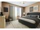 Comfortable bedroom with modern decor, a cozy bed, and natural light streaming through the window at 20922 E Crestline Cir, Centennial, CO 80015