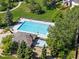 Aerial view of a large community pool with lounge chairs, mature trees, and a nearby building at 20922 E Crestline Cir, Centennial, CO 80015