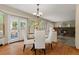 Cozy dining area with French doors, leading to an outdoor patio and brick fireplace view at 20922 E Crestline Cir, Centennial, CO 80015