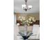 Close-up of the dining table centerpiece, showcasing a decorative vase with floral arrangement at 20922 E Crestline Cir, Centennial, CO 80015