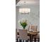 Close-up of an elegant dining table with place settings, floral centerpiece, and a modern chandelier above at 20922 E Crestline Cir, Centennial, CO 80015