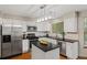 Well-equipped kitchen with white cabinets, dark countertops, stainless steel appliances, and a central island at 20922 E Crestline Cir, Centennial, CO 80015