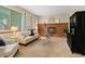 Living room with a brick fireplace, large windows, and neutral decor at 20922 E Crestline Cir, Centennial, CO 80015
