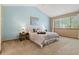 Bright bedroom featuring a vaulted ceiling, carpet floors, and a large window at 20922 E Crestline Cir, Centennial, CO 80015