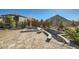 A backyard with a hot tub and a stone patio surrounded by landscaping features at 1715 Pioneer Cir, Lafayette, CO 80026