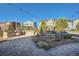 Beautiful backyard featuring a stone patio, grill, lush landscaping, and inviting lighting at 1715 Pioneer Cir, Lafayette, CO 80026