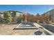 Relaxing backyard featuring a sunken hot tub with stone surround and privacy fencing at 1715 Pioneer Cir, Lafayette, CO 80026