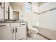 A clean bathroom featuring a sink vanity, toilet and tiled bath with shower at 1715 Pioneer Cir, Lafayette, CO 80026