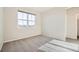A cozy bedroom with neutral paint, carpet flooring and a large window at 1715 Pioneer Cir, Lafayette, CO 80026
