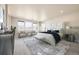 This bedroom is furnished with a cushioned bed frame and bench, complemented by a stylish sitting area with chairs and natural lighting at 1715 Pioneer Cir, Lafayette, CO 80026