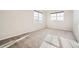 A bright bedroom with neutral paint, carpet flooring and two large windows at 1715 Pioneer Cir, Lafayette, CO 80026