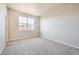 A bright bedroom with neutral paint, carpet flooring and a large window at 1715 Pioneer Cir, Lafayette, CO 80026