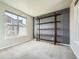 Bright bedroom featuring a large window and a unique dark wood shelving unit on a gray accent wall at 1715 Pioneer Cir, Lafayette, CO 80026