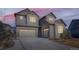 Two-story home with a three-car garage and classic gray and brown color scheme at 1715 Pioneer Cir, Lafayette, CO 80026