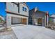 Charming home featuring spacious garages with open doors and a paved driveway at 1715 Pioneer Cir, Lafayette, CO 80026