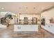 Well-lit kitchen features a central island with modern appliances and staircase at 1715 Pioneer Cir, Lafayette, CO 80026