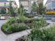 Lush backyard landscaping featuring a stone patio, garden, and string lights for ambiance at 1715 Pioneer Cir, Lafayette, CO 80026