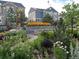 Beautifully landscaped yard with colorful flowers and lush greenery surrounding a stone seating area at 1715 Pioneer Cir, Lafayette, CO 80026