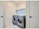 Convenient laundry room with modern washer and dryer set and practical shelving at 1715 Pioneer Cir, Lafayette, CO 80026