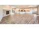 Open floorplan featuring a living area with fireplace, kitchen with island, and staircase at 1715 Pioneer Cir, Lafayette, CO 80026