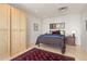 Comfortable bedroom with neutral walls, wood floors, red rug, and closet at 2000 Little Raven St # 501, Denver, CO 80202