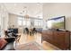 Bright living area with hardwood floors, dining space, and large windows overlooking the city at 2000 Little Raven St # 501, Denver, CO 80202